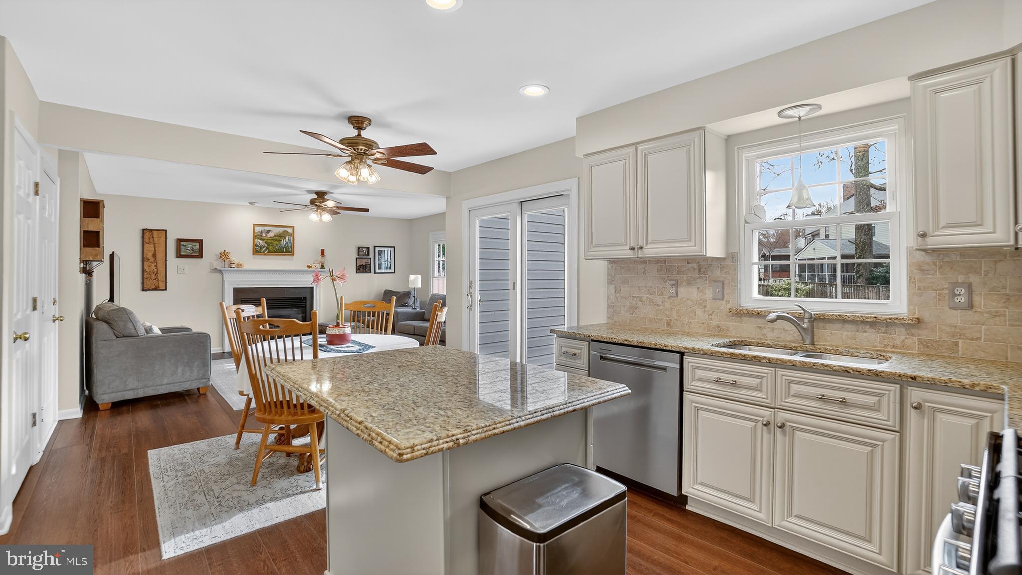 2709 Bains Court Crofton, MD 21114 - Photo 17 of 63 a kitchen with kitchen island granite countertop a sink cabinets and wooden floor