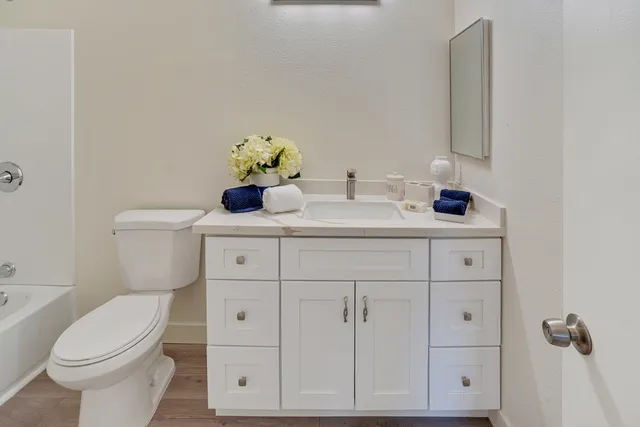 a bathroom with a sink toilet and a mirror