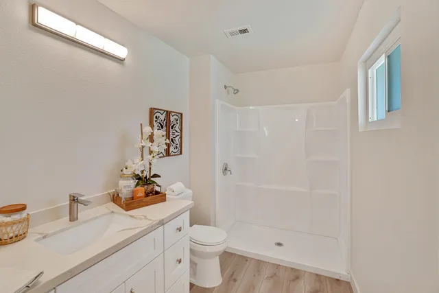 a bathroom with a sink toilet and shower