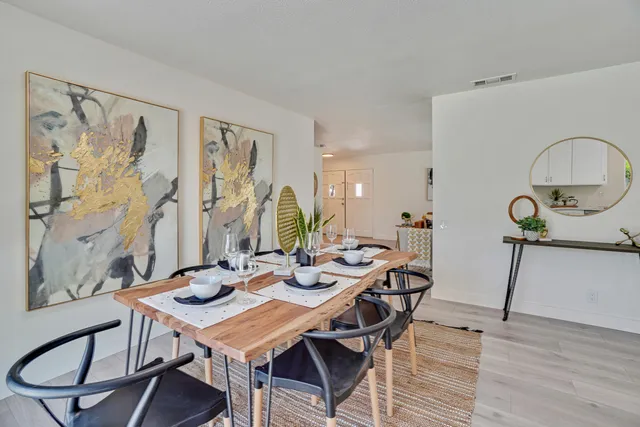 a view of a dining room with furniture and wooden floor