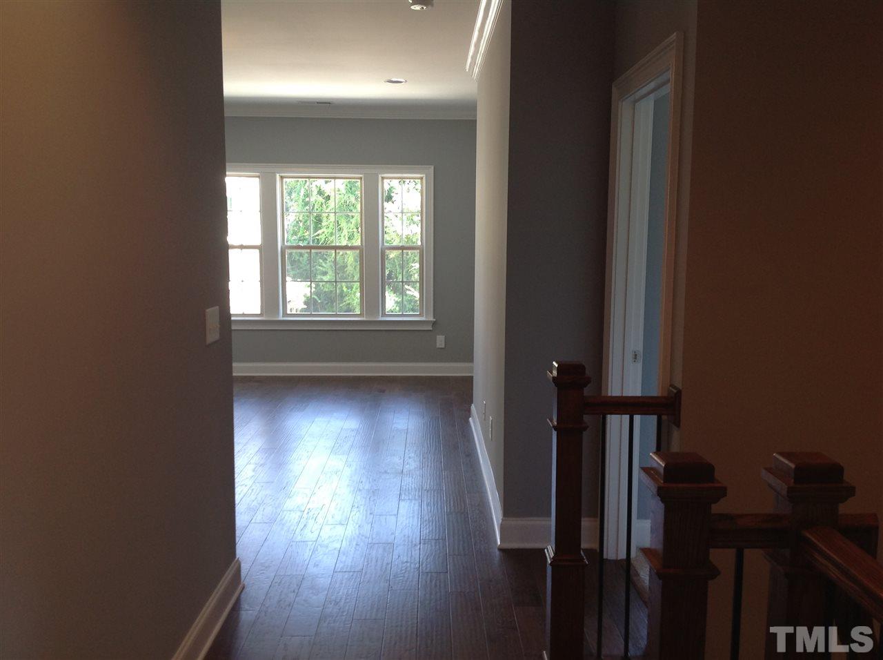 3619 Rolston Drive, Unit 10 Raleigh, NC 27609 - Photo 7 of 14 a view of a hallway with wooden floor and a window