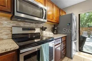 a kitchen with stainless steel appliances granite countertop a stove and a microwave