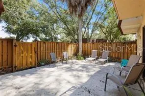 a backyard of a house with table and chairs