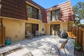 a view of a building with a chairs and table in a patio