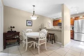 a view of a dining room with furniture and a chandelier
