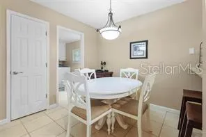 a dining room with furniture and chandelier