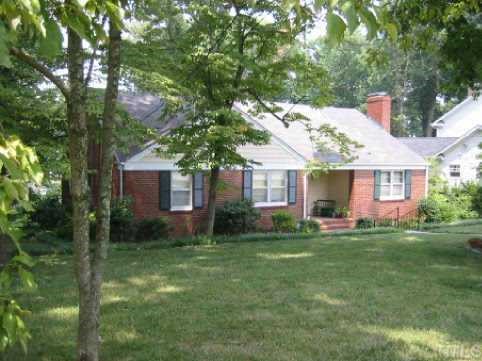 1713 Canterbury Road Raleigh, NC 27608 - Photo 1 of 1 a front view of a house with a garden and trees