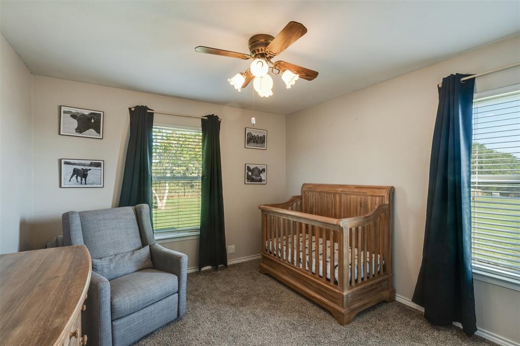 917 Cole Lane Sunset, TX 76270 - Photo 16 of 40 a bed sitting in a bedroom next to a window