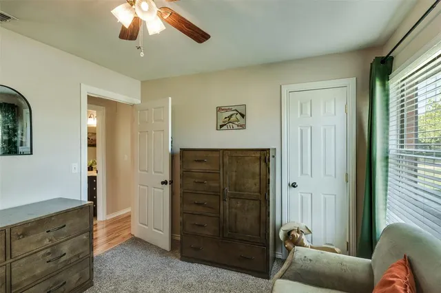 a bathroom with a sink mirror and toilet