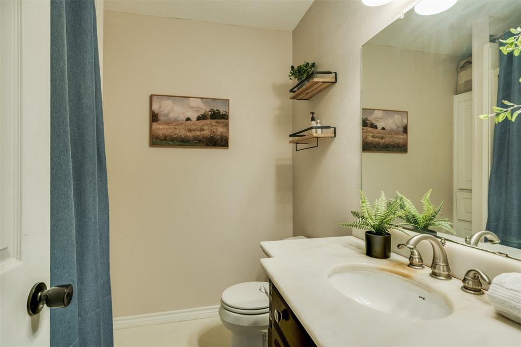 917 Cole Lane Sunset, TX 76270 - Photo 19 of 40 a bathroom with a sink mirror and toilet