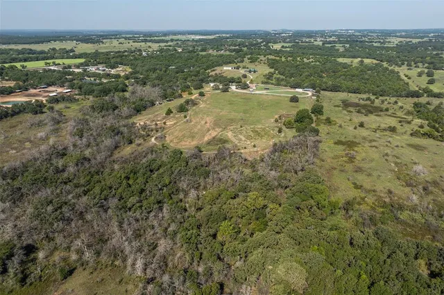 an aerial view of a house with outdoor space and lake view