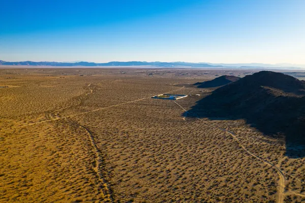 a view of an ocean beach and mountain