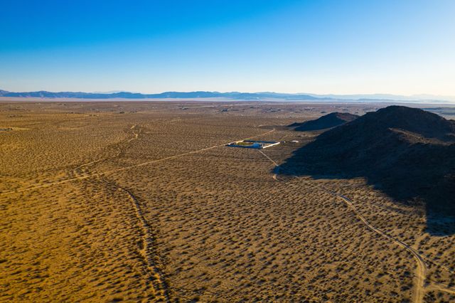 a view of an ocean beach and mountain