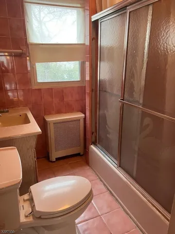 a kitchen with granite countertop a stove a sink and a refrigerator