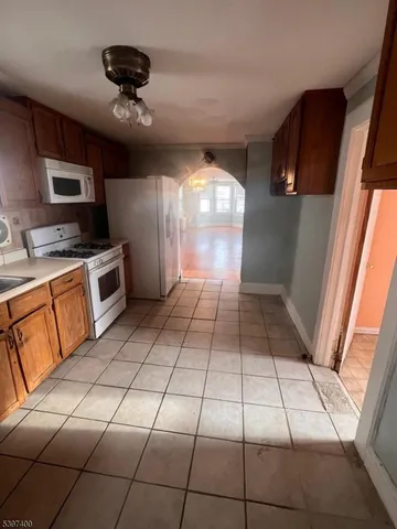 a kitchen with stainless steel appliances a stove a sink and a refrigerator