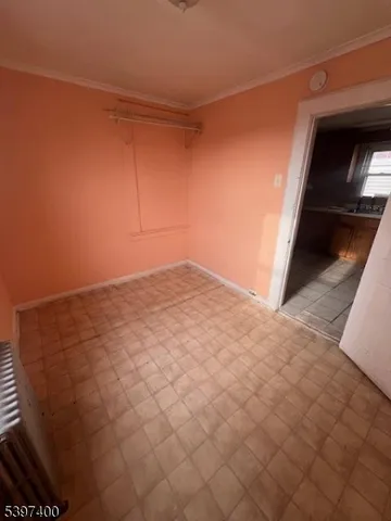 a view of a hallway with wooden floor and a balcony