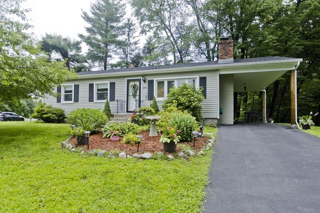 1041 Burts Pit Road Northampton, MA 01062 - Photo 1 of 22 a front view of a house with a garden and plants