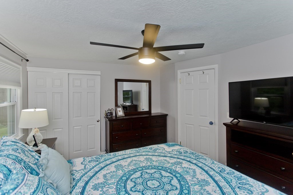 1041 Burts Pit Road Northampton, MA 01062 - Photo 13 of 22 a bedroom with a bed and a flat tv screen on the dresser