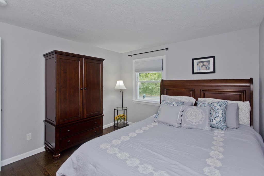 1041 Burts Pit Road Northampton, MA 01062 - Photo 16 of 22 a bedroom with a bed and wooden floor