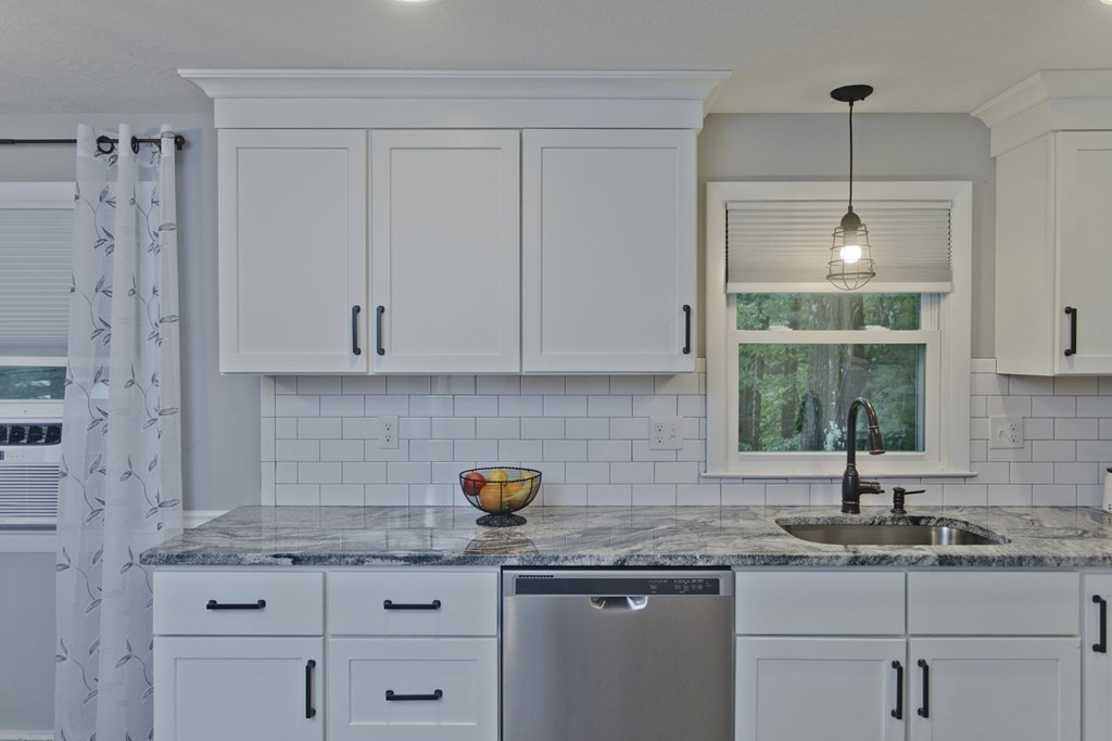 1041 Burts Pit Road Northampton, MA 01062 - Photo 2 of 22 a kitchen with granite countertop a sink a window and cabinets
