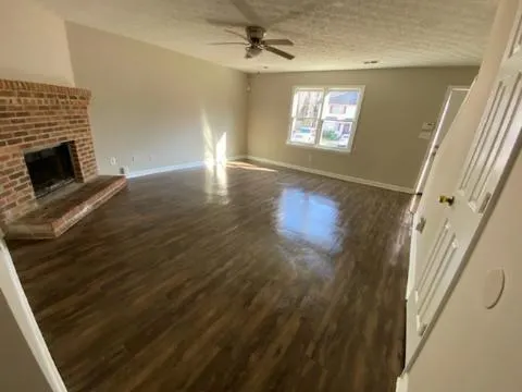 wooden floor in an empty room with a fireplace