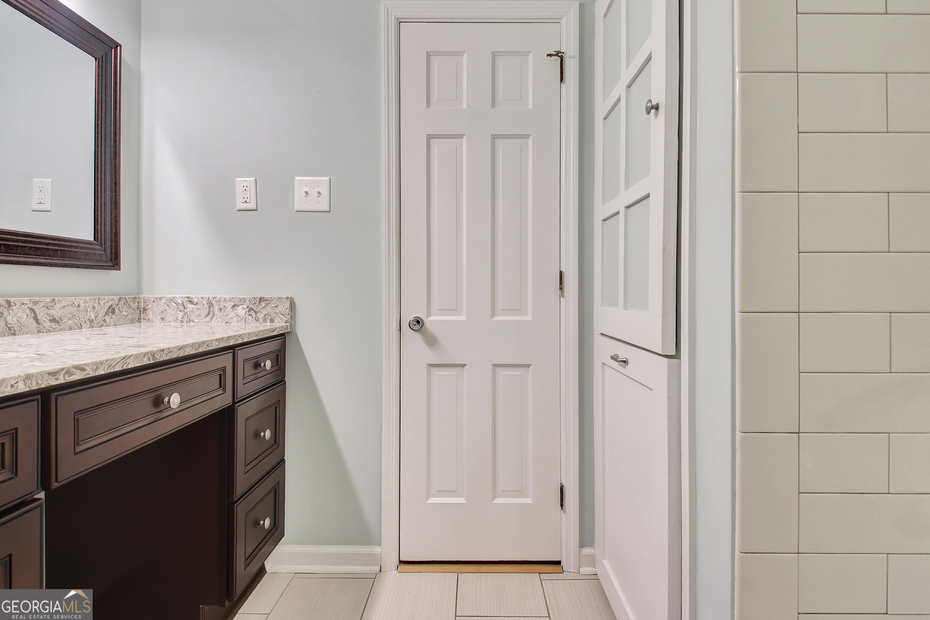 717 Tyrone Road Tyrone, GA 30290 - Photo 23 of 58 a bathroom with a granite countertop sink and a mirror