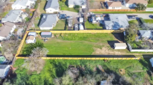 an aerial view of a residential houses with outdoor space