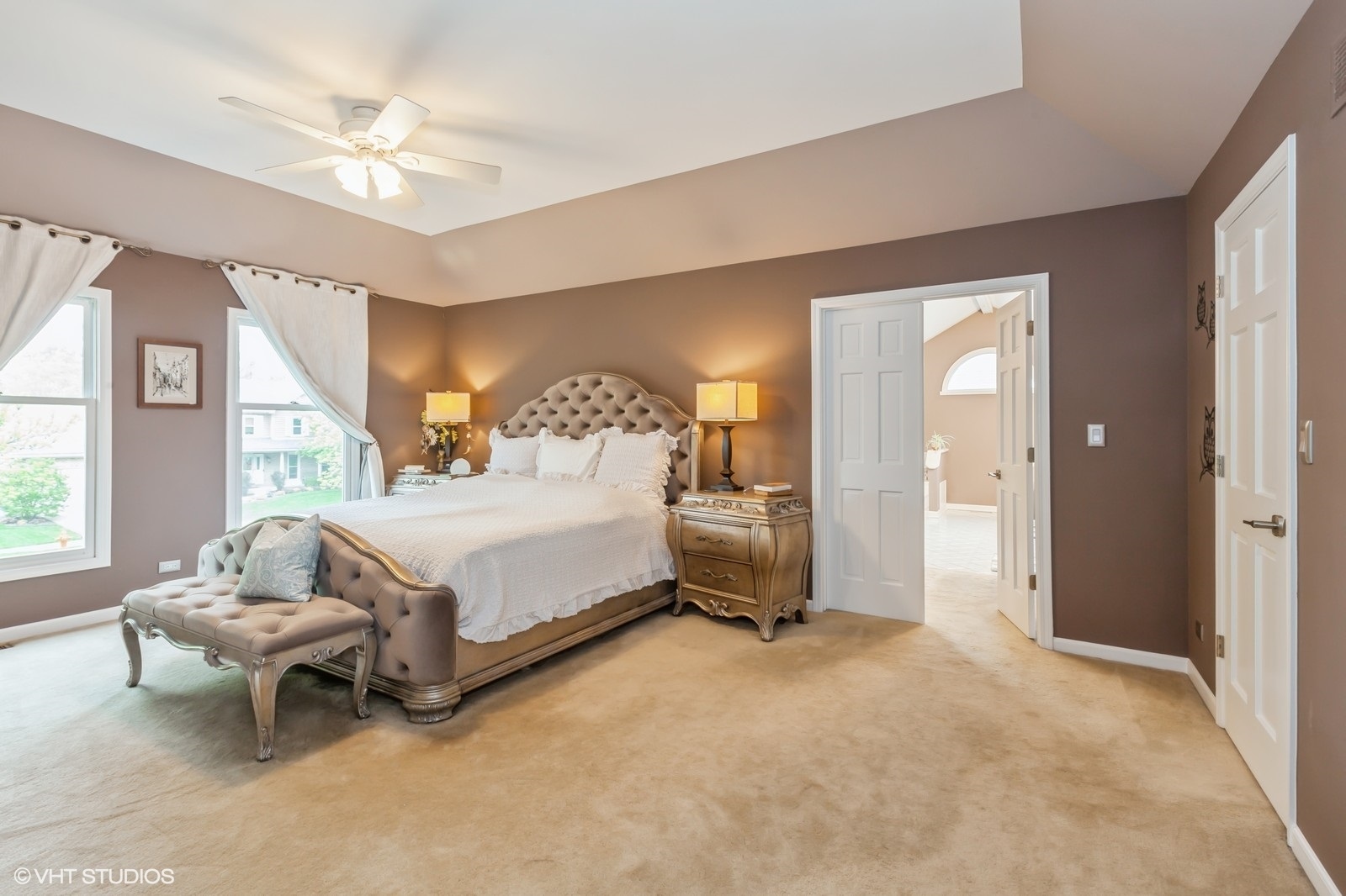 446 Quail Drive Naperville, IL 60565 - Photo 12 of 24 a spacious bedroom with a bed and a chandelier