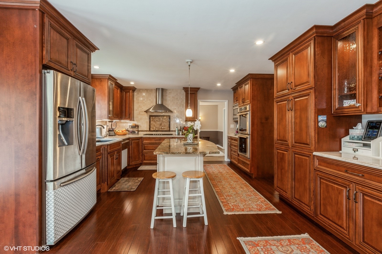 446 Quail Drive Naperville, IL 60565 - Photo 5 of 24 a kitchen with stainless steel appliances a refrigerator and wooden floors