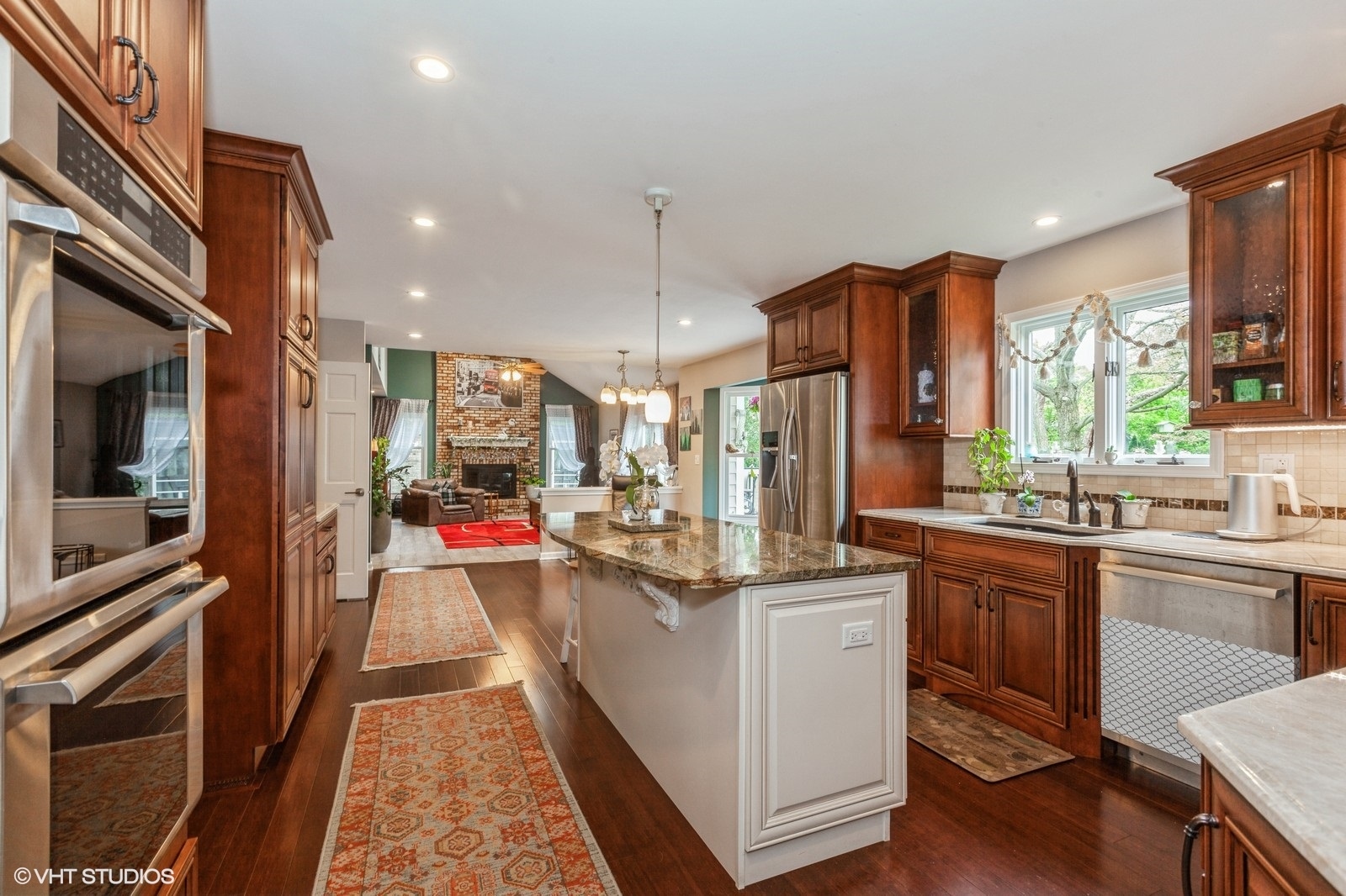 446 Quail Drive Naperville, IL 60565 - Photo 6 of 24 a view of a kitchen with kitchen island stainless steel appliances a stove and a sink