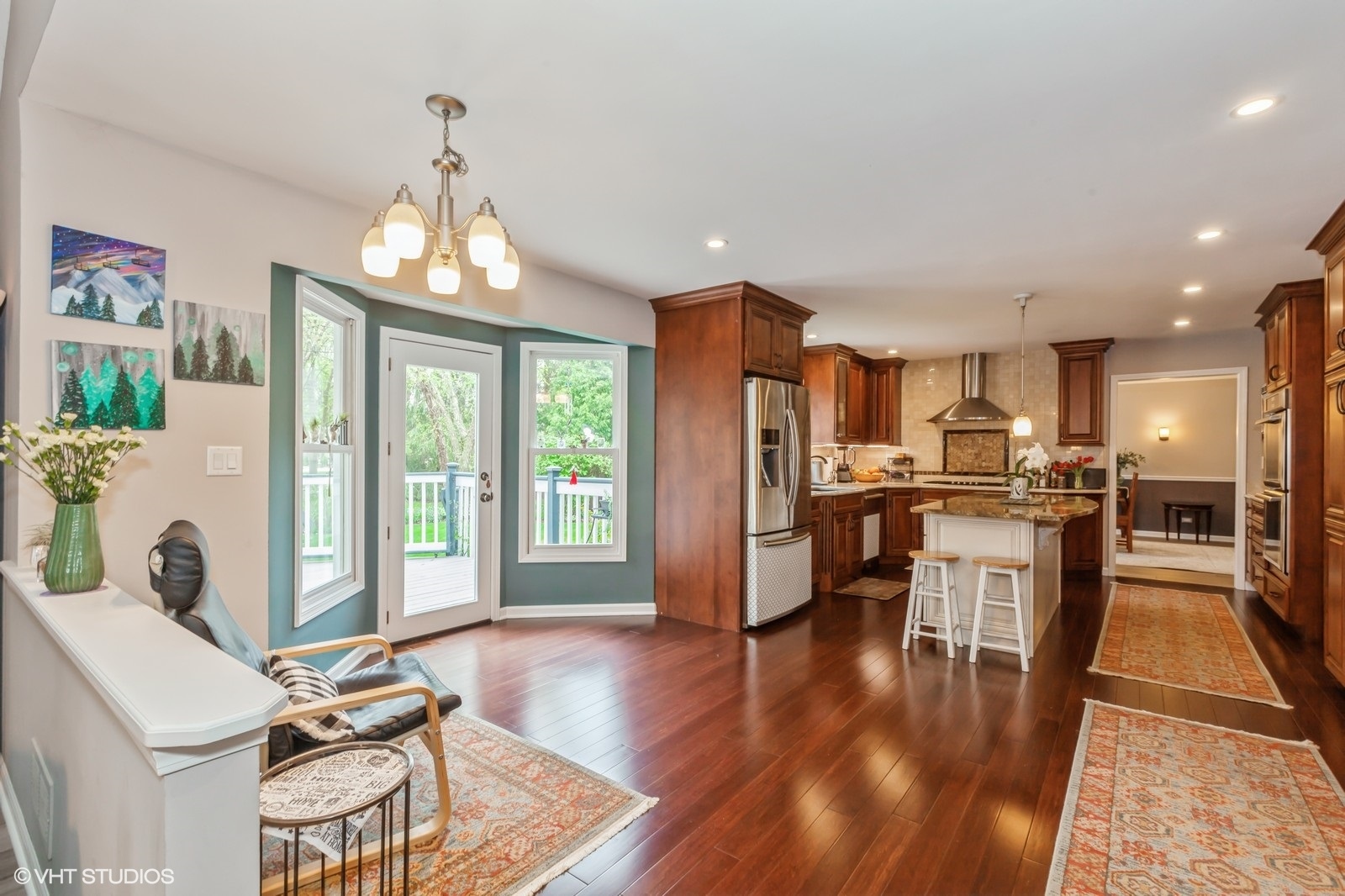 446 Quail Drive Naperville, IL 60565 - Photo 7 of 24 a view of a dining room with furniture a chandelier and wooden floor