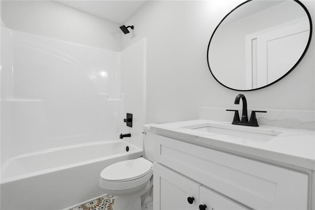 134 Henry Meyer Road Winterville, GA 30683 - Photo 27 of 34 a bathroom with a sink a toilet and a mirror