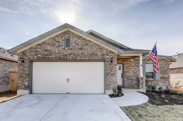 a kitchen with stainless steel appliances a table chairs refrigerator and a sink