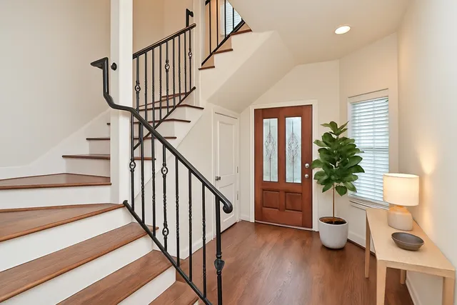 a view of entryway and hall with wooden floor