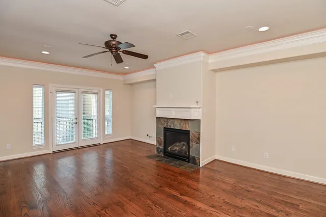 a view of empty room with wooden floor and fireplace