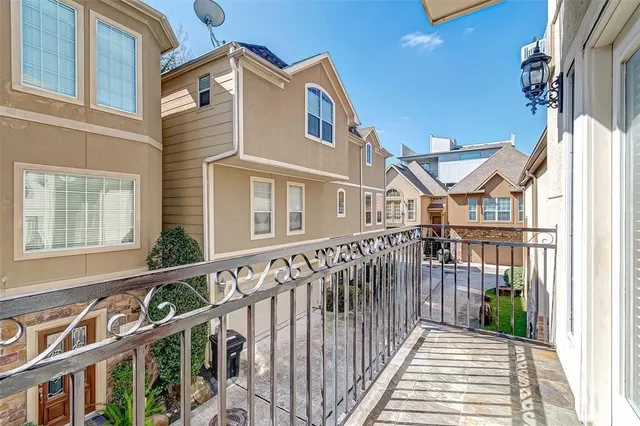 a view of a brick house with large windows