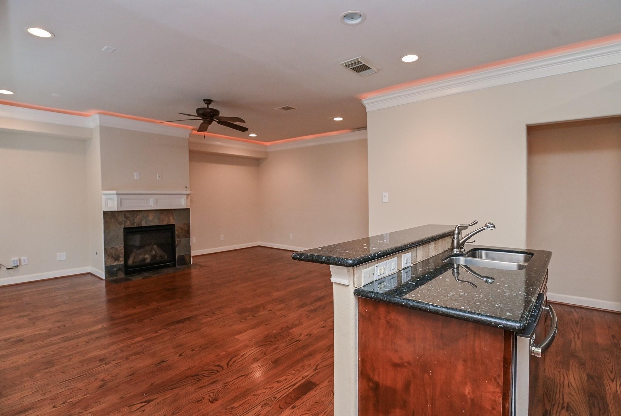 5813 Washington Avenue, Unit B Houston, TX 77007 - Photo 18 of 36 a view of a livingroom with wooden floor and a fireplace