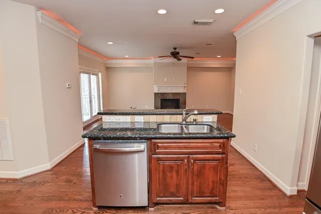 a kitchen with stainless steel appliances granite countertop a stove and a sink