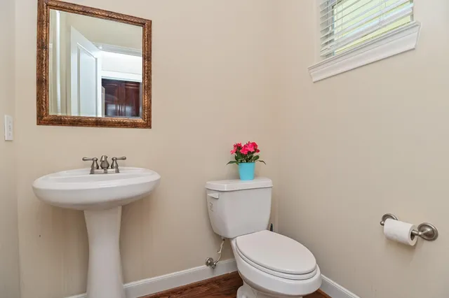 a bathroom with a toilet sink and mirror