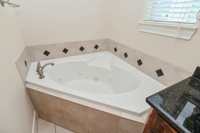a close up of a bathtub in a white room