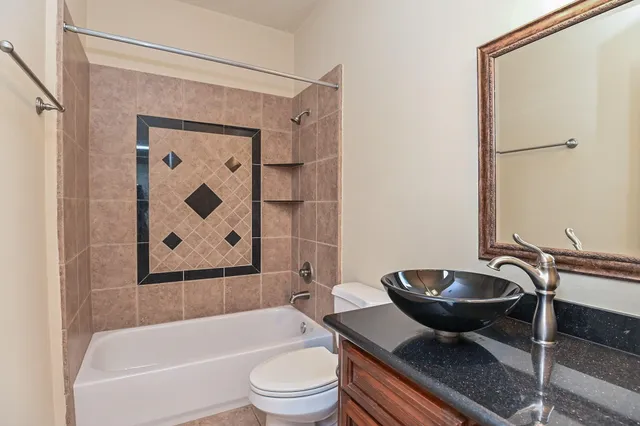 a bathroom with a bathtub and a toilet