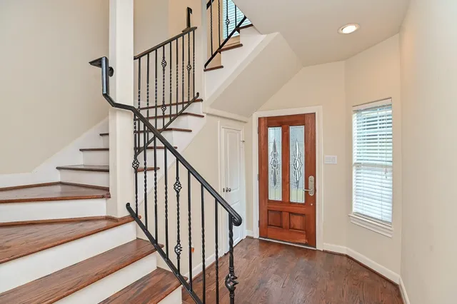 a view of an entryway with wooden floor