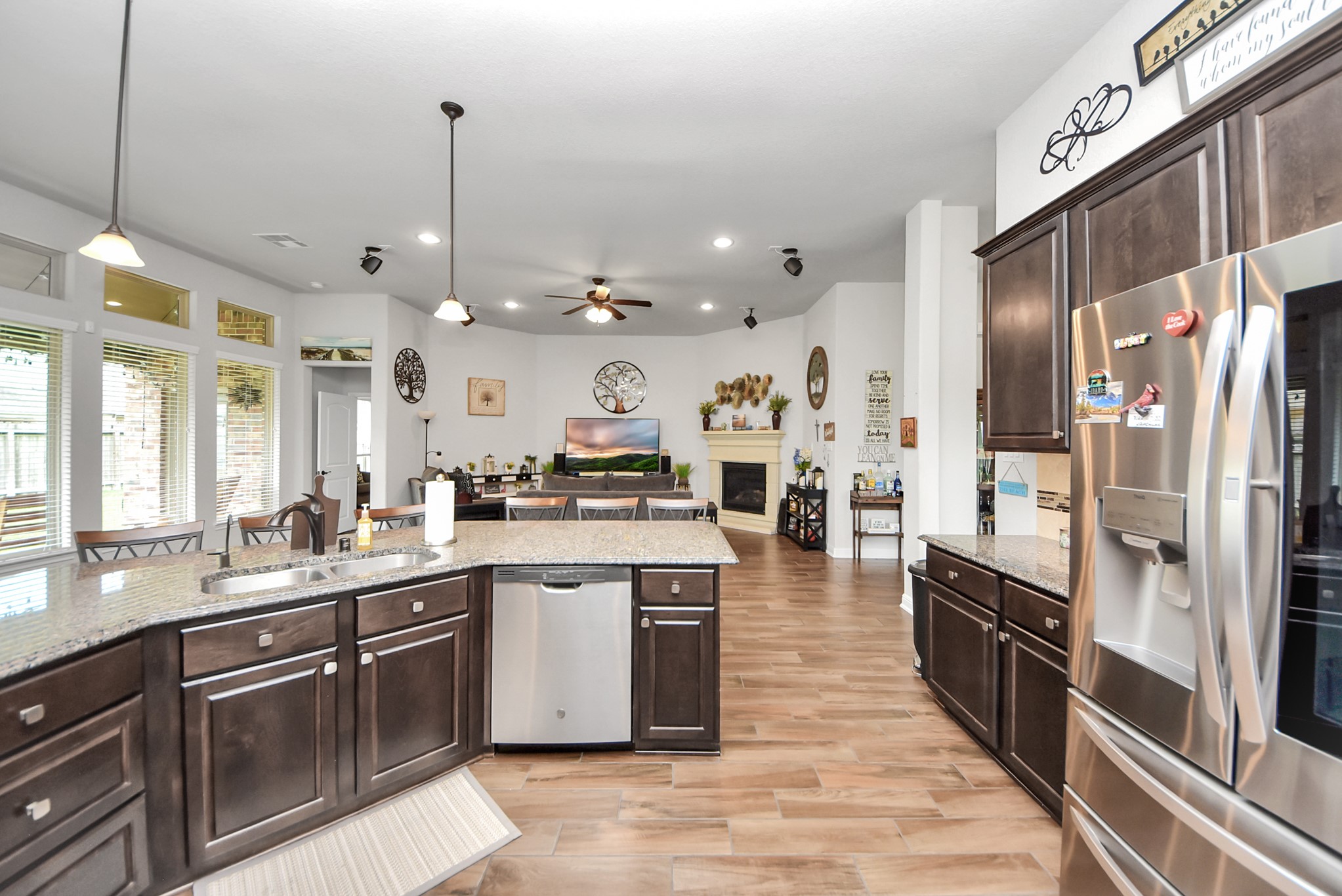 24503 Eucalyptus Way Spring, TX 77373 - Photo 5 of 27 a large kitchen with stainless steel appliances kitchen island granite countertop a large counter top a sink a stove and refrigerator