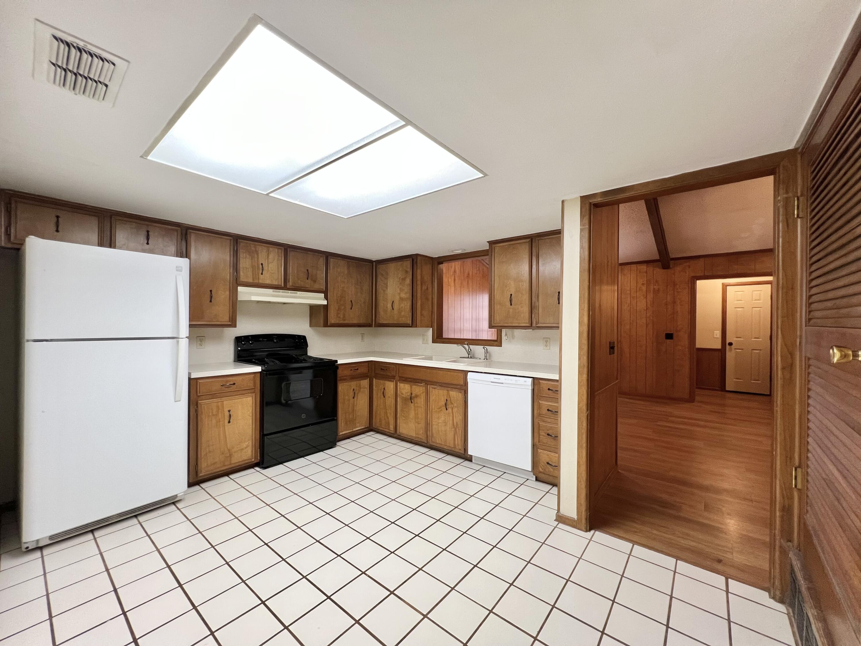 5113 13th Street, Unit A Lubbock, TX 79416 - Photo 12 of 25 a kitchen with a refrigerator and a sink