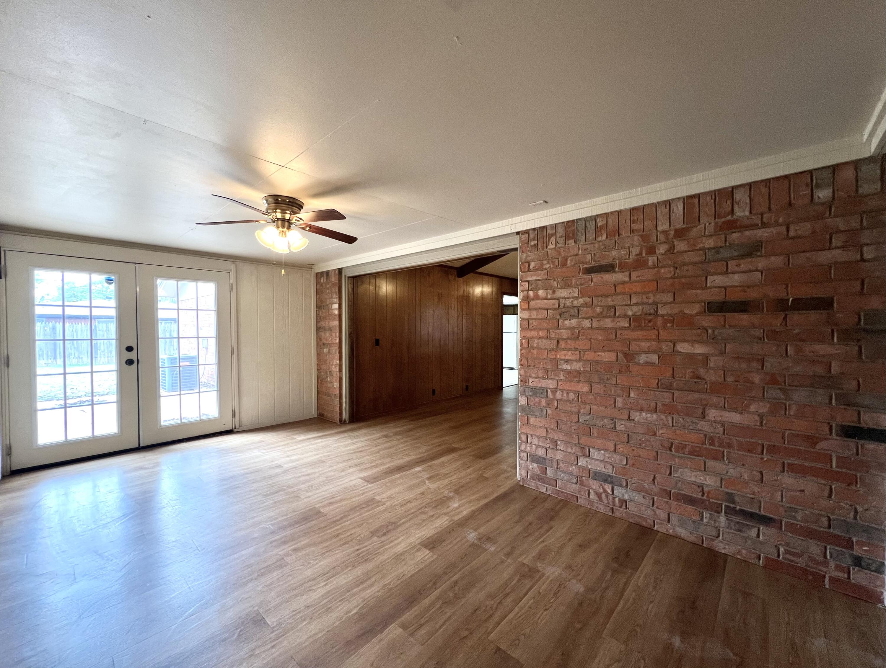 5113 13th Street, Unit A Lubbock, TX 79416 - Photo 15 of 25 wooden floor in an empty room with a window