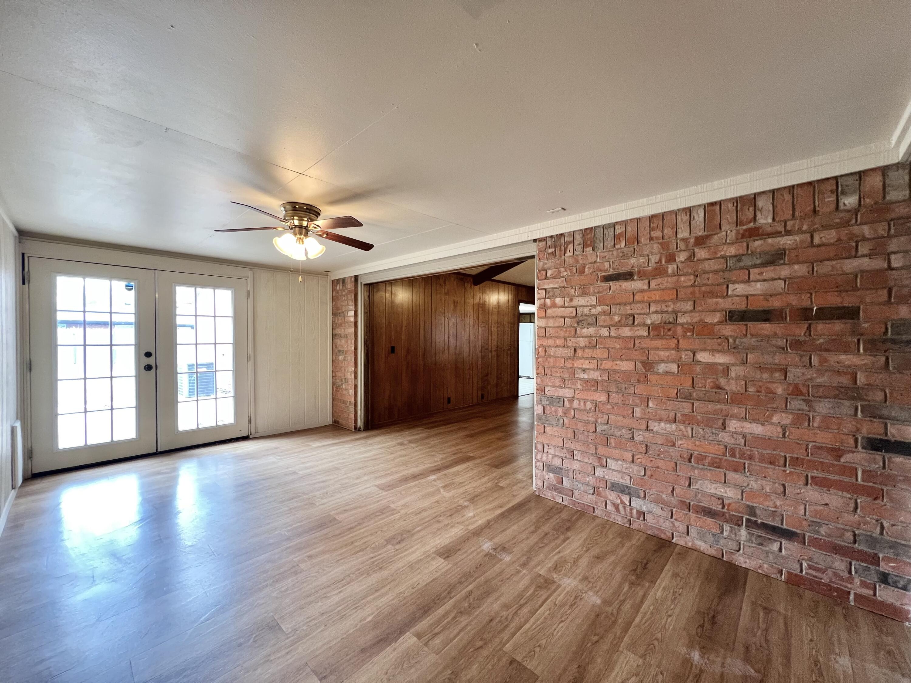 5113 13th Street, Unit A Lubbock, TX 79416 - Photo 16 of 25 a view of an empty room with wooden floor and a window