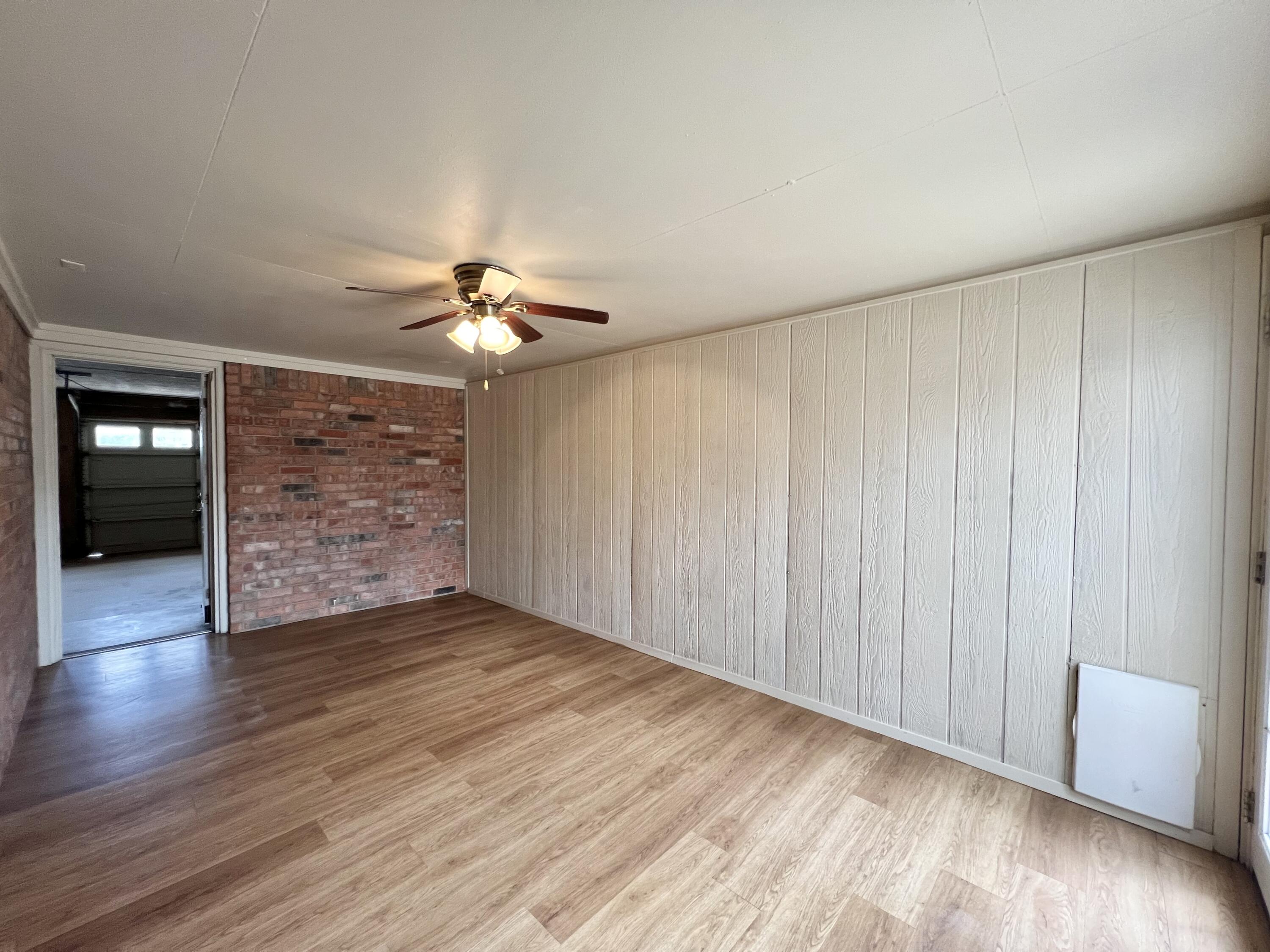 5113 13th Street, Unit A Lubbock, TX 79416 - Photo 18 of 25 wooden floor in an empty room with a window