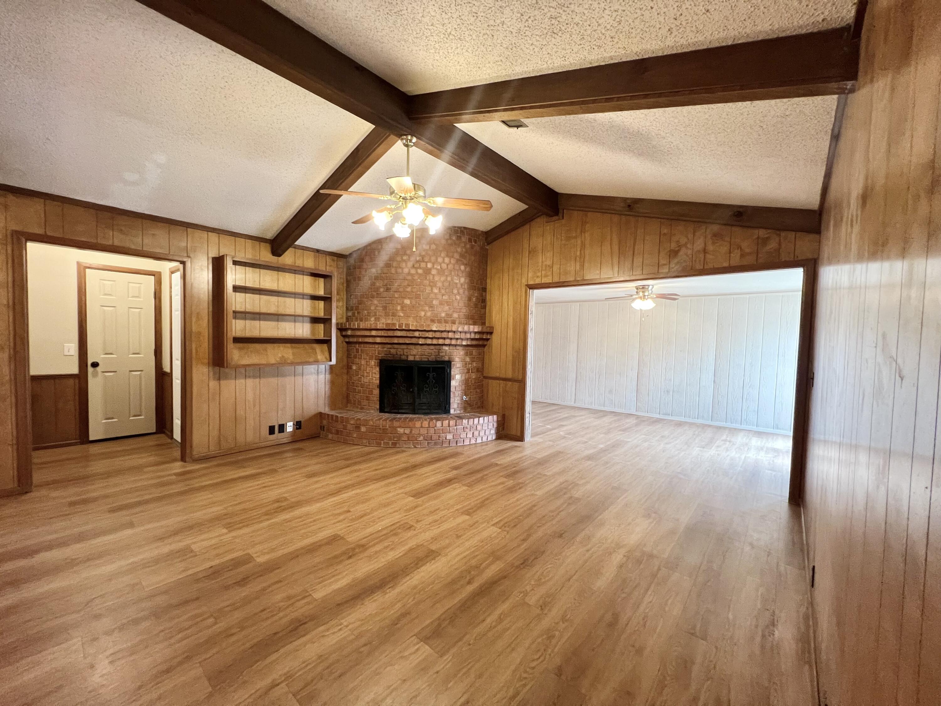 5113 13th Street, Unit A Lubbock, TX 79416 - Photo 20 of 25 a view of empty room with wooden floor and fireplace