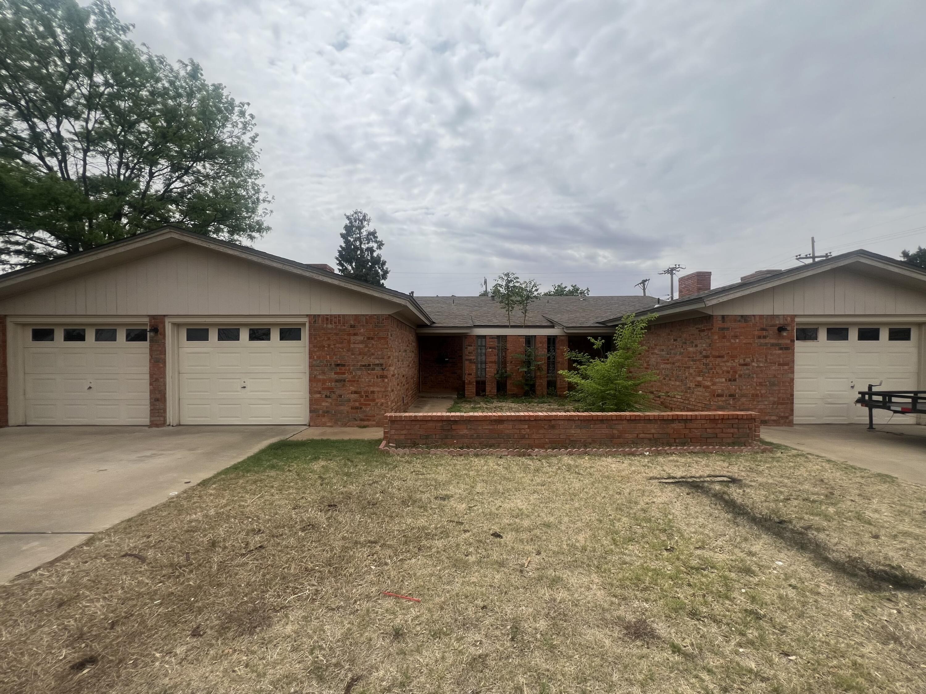 5113 13th Street, Unit A Lubbock, TX 79416 - Photo 25 of 25 a house with trees in the background