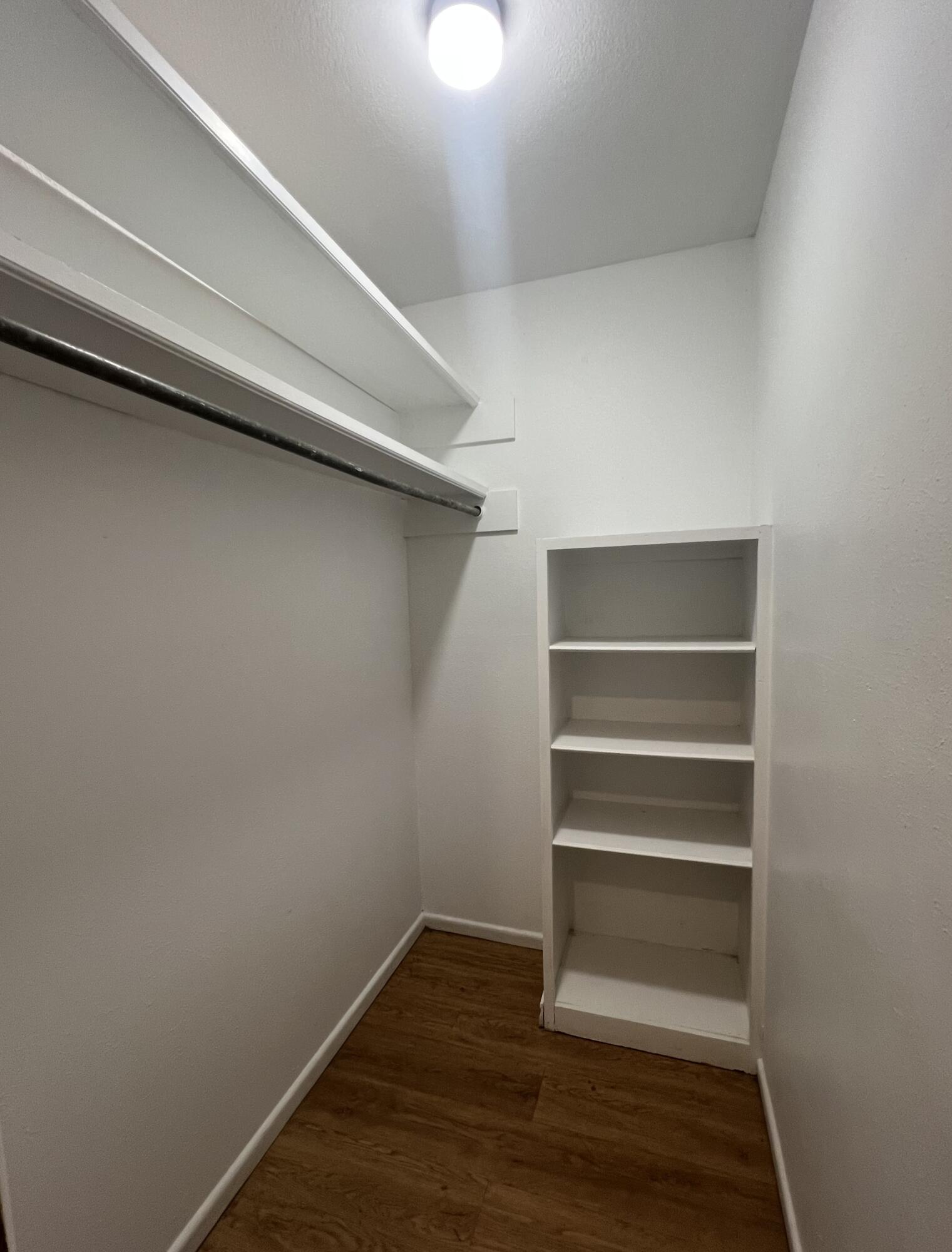 5113 13th Street, Unit A Lubbock, TX 79416 - Photo 3 of 25 a view of walk in closet with empty racks